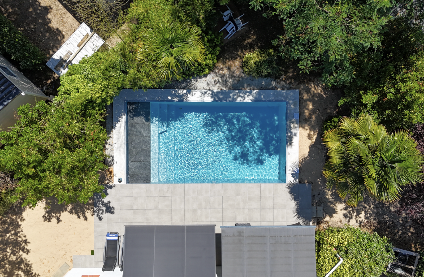 Piscine coque polyester dans un jardin, illustrant le budget à prévoir pour un projet en 2026